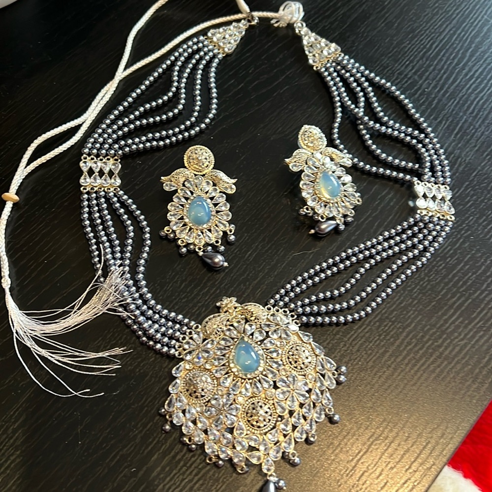 Brand new necklace and earring set.silver,blue,gray,gold.white silk tassel